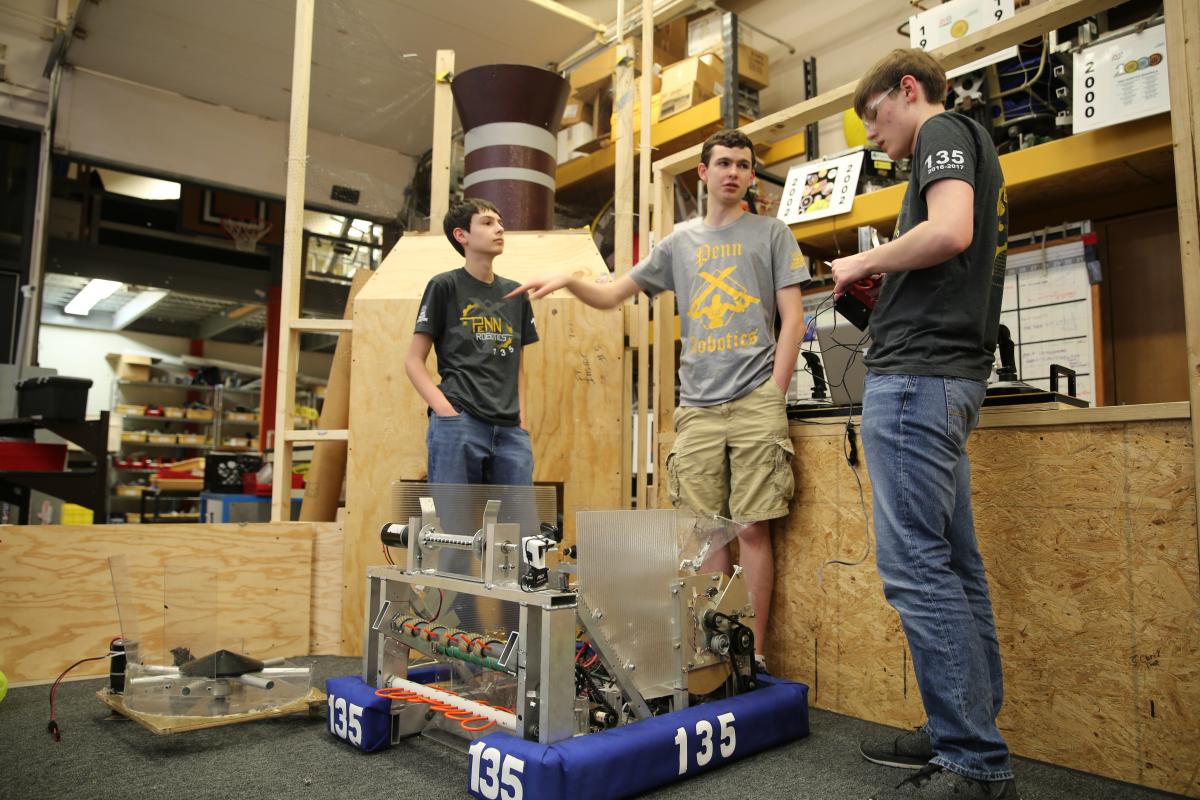 Team members work on test robot