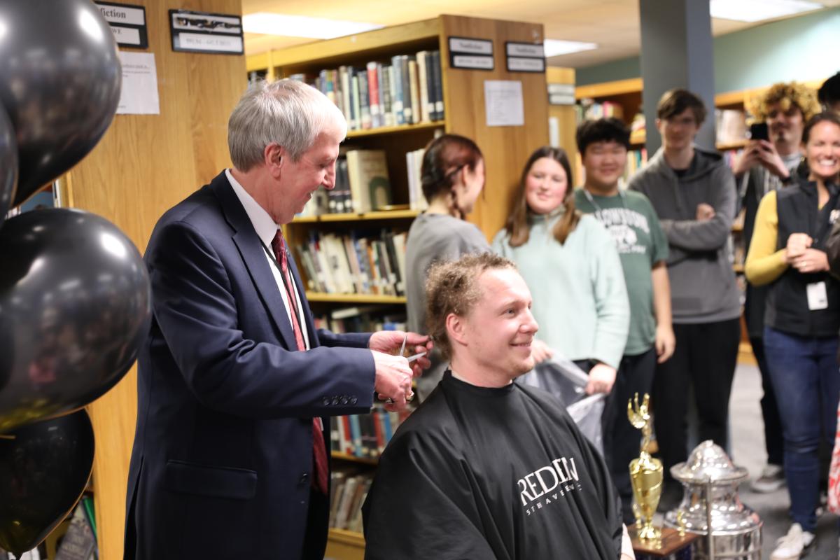 Mr. Starkweather getting his head shaved