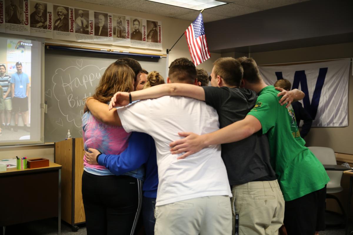 Danielle's students hug her