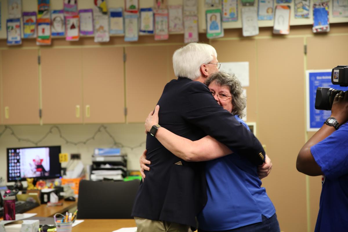 Mr. & Mrs. Riley hug