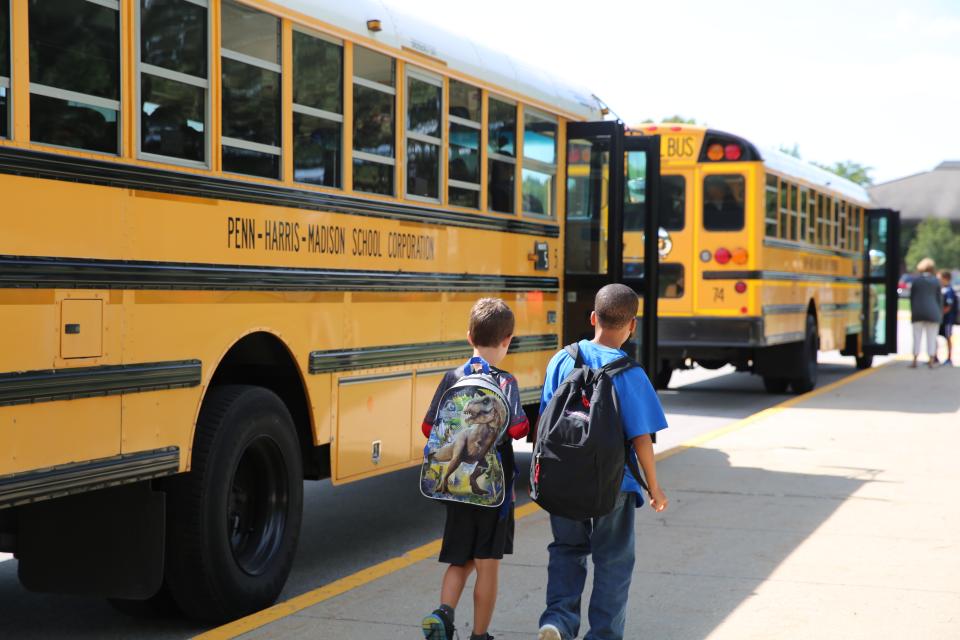 Students loading Penn-Harris-Madison school buses