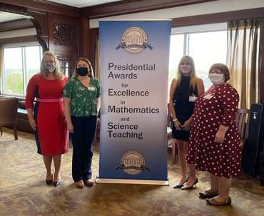 Ms. Amanda Fox (green shirt) with Indiana Secretary of Education Dr. Katie Jenner (red dress)