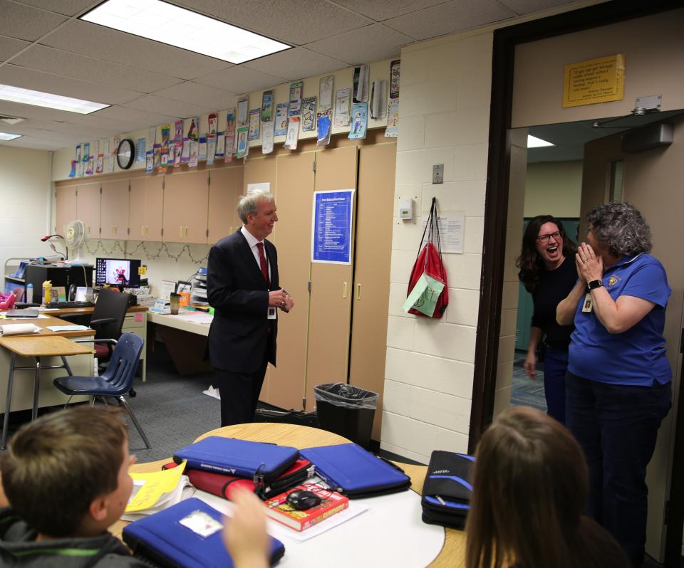 Dr. Thacker and Principal Dean-Null surprise Mrs. Lee Riley 