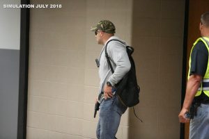 Police officer simulates active shooter in safety training exercise