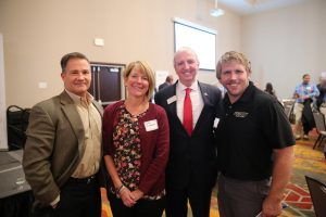 Penn parents Chris & Nancy Hildebrandt (mother of alumna wrestler Sarah Hildebrandt) with Dr. Thacker and Penn Wrestling Coach Brad Harper