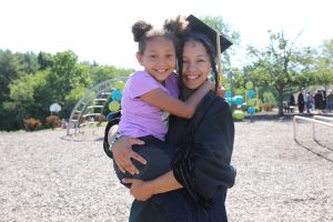 Elm Road graduate holding younger sister