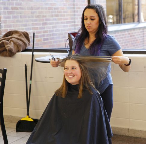 Penn student getting hair cut for "Short Hair Because we Care" hair donation event