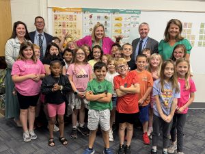 teacher and administrators with students