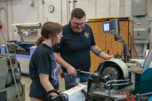 Manufacturing teacher with student
