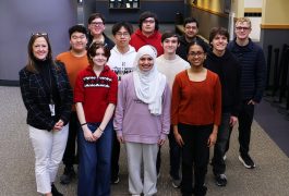 Students and principal standing in hallway of Penn High School