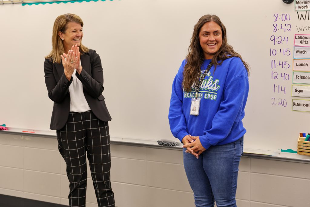 Dr. Heather Short claps and congratulates Josie Engdahl after surprising her with the news that she's PHM's 2026 Elementary Teacher of the Year