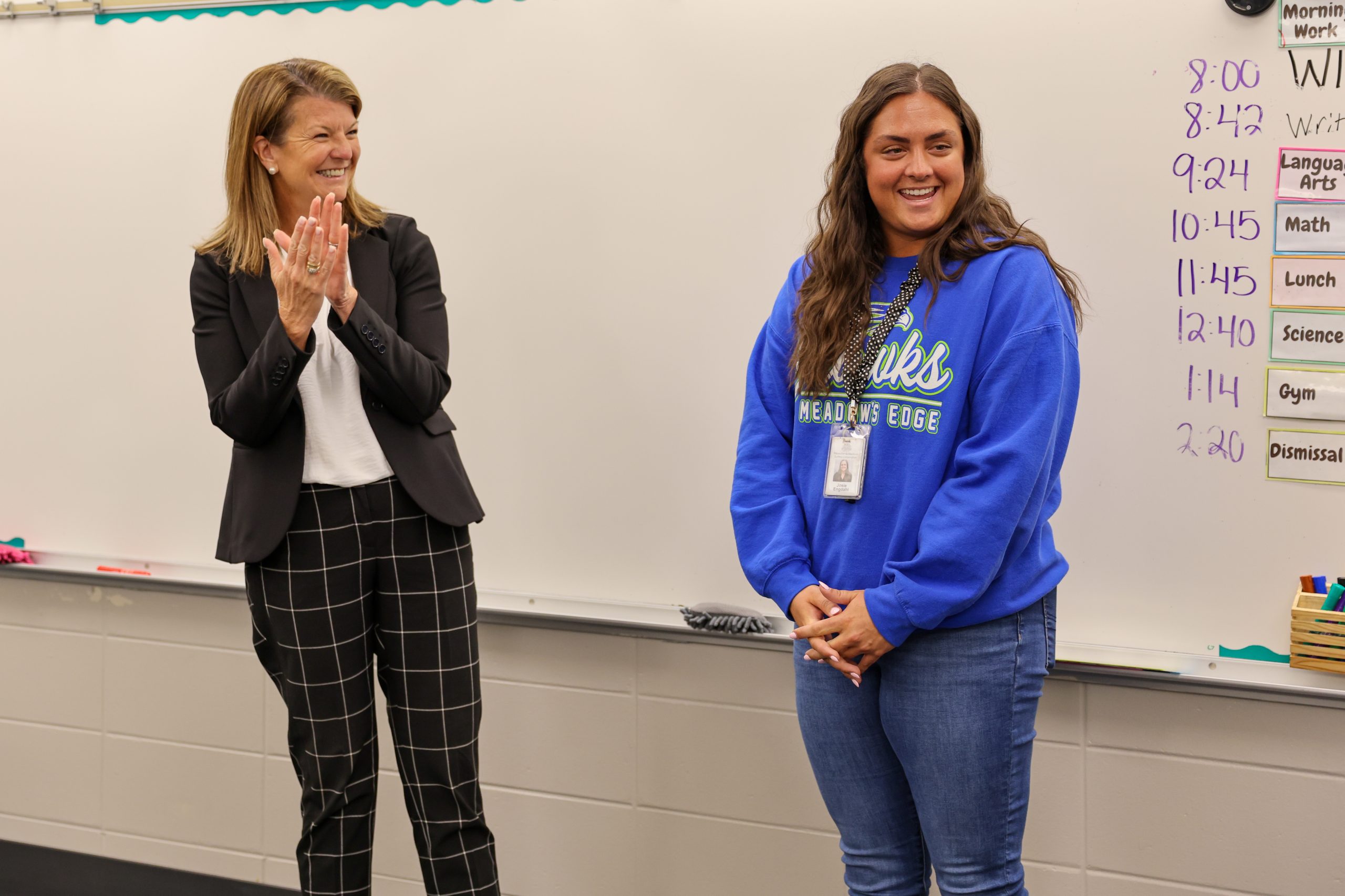 Dr. Heather Short claps and congratulates Josie Engdahl after surprising her with the news that she's PHM's 2026 Elementary Teacher of the Year