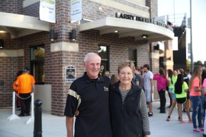 Larry and Judy Beehler pose for a picture in front of the Larry Beehler Ticket Center.