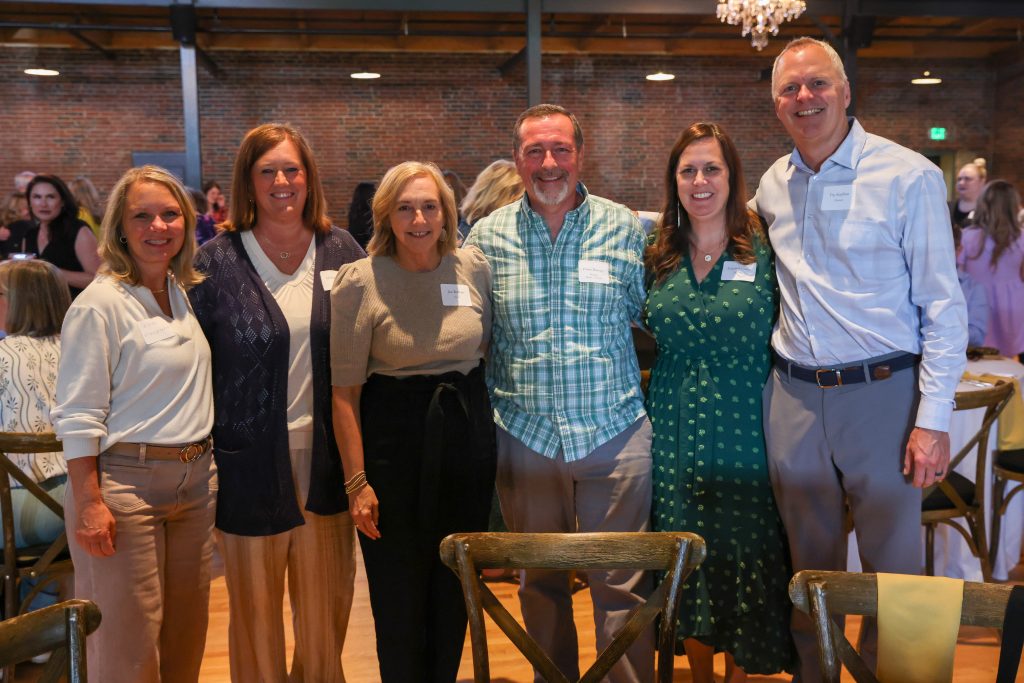 Group of people posing for a picture at an event.