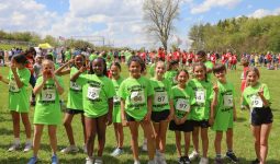 Mary Frank students (wearing lime green shirts) getting ready for Running is Elementary race event and to cheer on their classmates