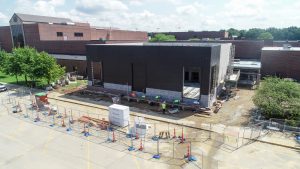 A new building being constructed on a college campus.