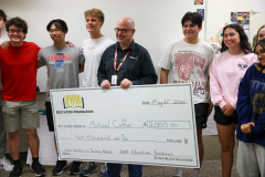 The group is posing in front of a check for $2000, an award for 1st place in the Arter competition.