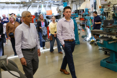 People walking through a factory.